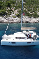 Catamaran at anchor in secluded island