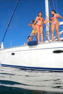 Group of friends jumping from sailboat