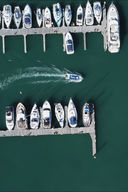 Speedboat navigating around boats in marina